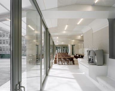 A glass façade floods the space with light