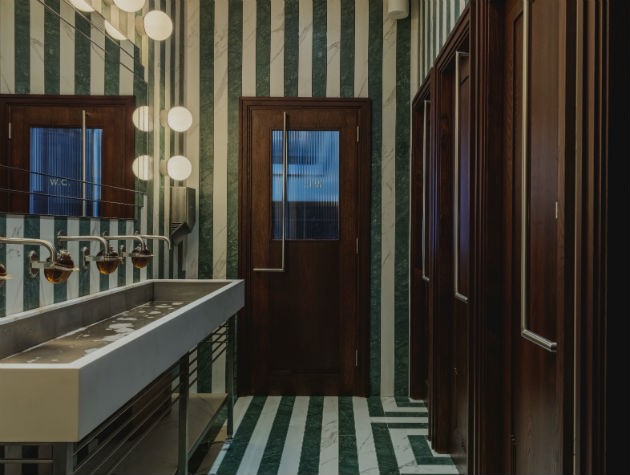 green and white striped tiles in a restaurant bathroom